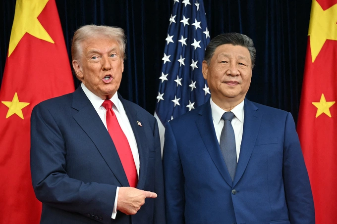 US President Donald Trump (L) and Chinas President Xi Jinping greet each other as they arrive for talks at the Gimhae Air Base, located next to the Gimhae International Airport in Busan on October 30, 2025. Photo by AFP