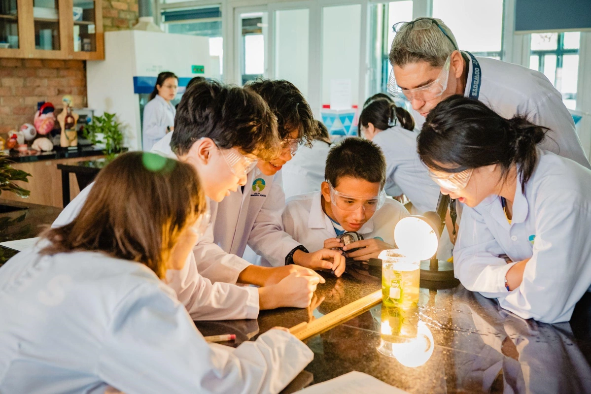 Teacher assisting student during application class. Photo courtesy of HAIS