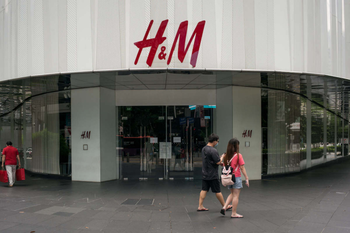 People walk past a temporarily closed H&M outlet along the Orchard Road during the Covid-19 crisis. Photo by ZUMA Press Wire via Reuters