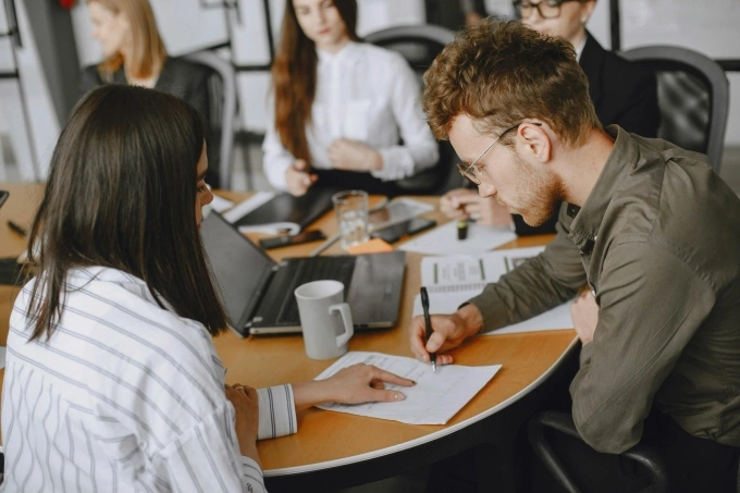 People engage in an office meeting. Illustration photo by Pexels
