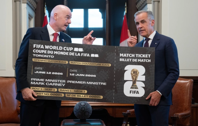 Canadian Prime Minister Mark Carney (R) receives a symbolic World Cup ticket from FIFA President Gianni Infantino in Ottawa, Ontario, on Oct. 10, 2025. Photo by AP