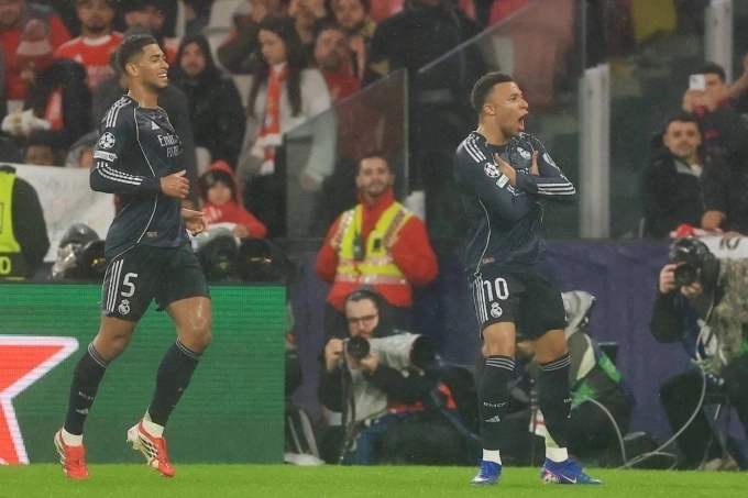 Real Madrids French forward #10 Kylian Mbappe (R) celebrates scoring his teams first goal past his teammate English midfielder #05 Jude Bellingham during the UEFA Champions League league phase day 8 football match between SL Benfica and Real Madrid CF at Estadio da Luz in Lisbon on Jan. 28, 2026. Photo by AFP