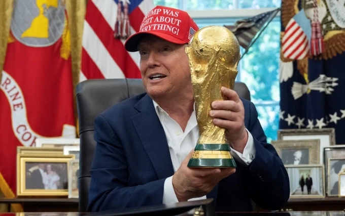 U.S. President Donald Trump holds the FIFA World Cup trophy. Photo by AFP