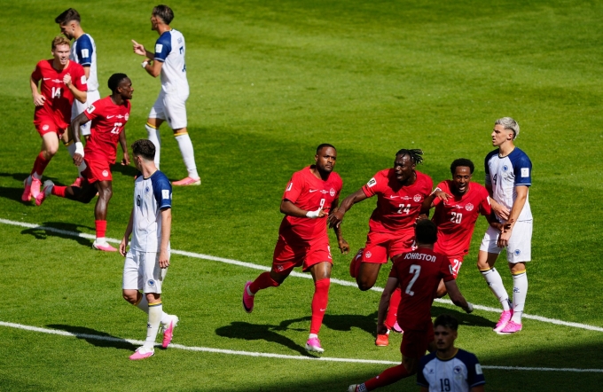 Canadian footballers (in red) celebrate an equalizer in their 1-1 draw with Bosnia and Herzegovina at the World Cup group stage in BMO Field Stadium, Toronto, Canada, June 13, 2026. Photo by Reuters