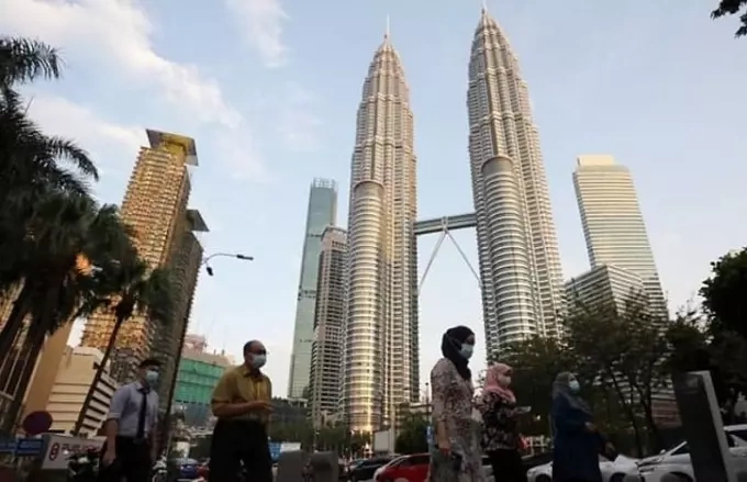 Malaysia jumps 8 places in global economic competitiveness ranking 1 People walk outside the Petronas Towers in Kuala Lumpur, Malaysia. Photo by Reuters