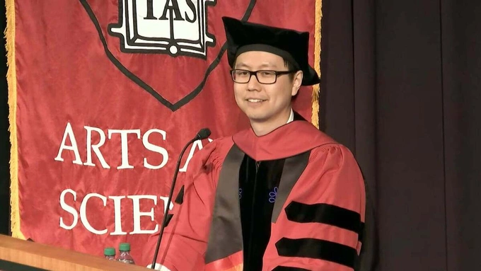 Joel Tan speaks at his PhD graduation ceremony at Harvard. Photo courtesy of Harvard Medical School/YouTube