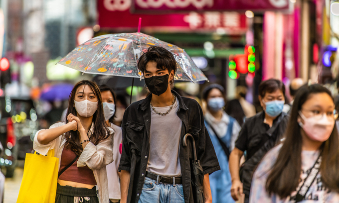 Young people walk on Sai Yeung Choi South Street in Mongkok. Photo by NurPhoto via AFP