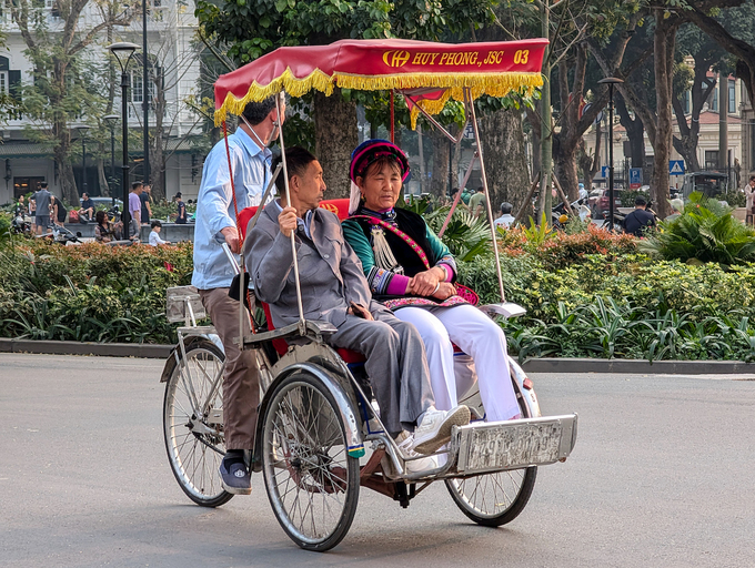 A group of tourists and locals take a peaceful cyclo ride through the streets of Hanoi, Vietnam, on March 22, 2025. Photo by NurPhoto via AFP