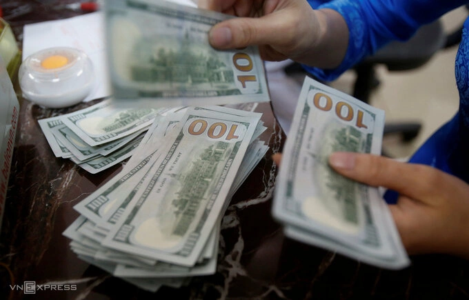 Dollar slides against dong 1 An employee of a bank counts US dollar notes at a branch in Hanoi, Vietnam May 16, 2016. Photo by Reuters