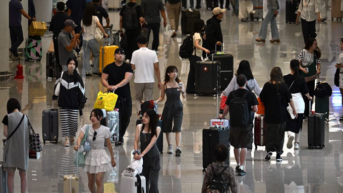 People walk through the Terminal 2 arrivals hall at Incheon International Airport in Incheon, South Korea, on Sept. 12, 2025. Photo by AFP