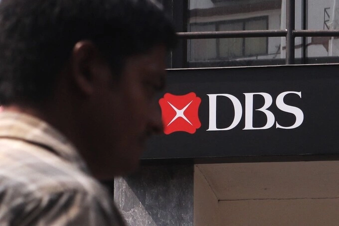 A man walks past a Development Bank of Singapore(DBS) logo in Mumbai, India, 28 September, 2022. Photo by NurPhoto via AFP