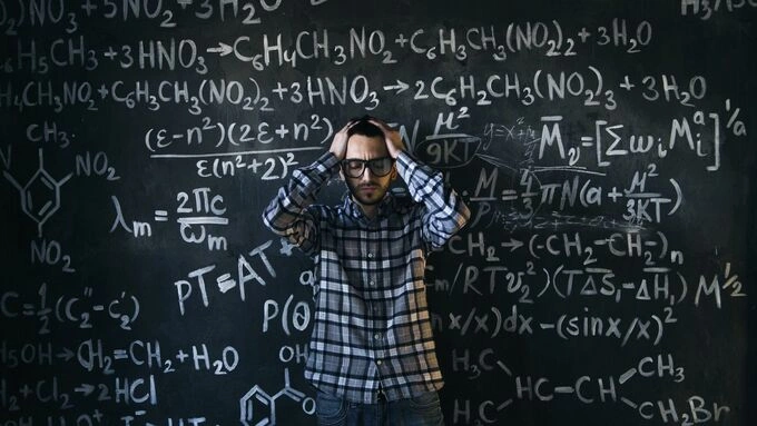 A person struggling with a complex formula on a blackboard. Pexels illustrations