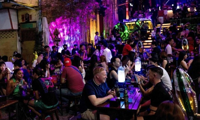 People enjoy a drink at a bar along the popular tourist and nightlife strip Khao San Road in Bangkok on Dec. 10, 2021. Photo by AFP