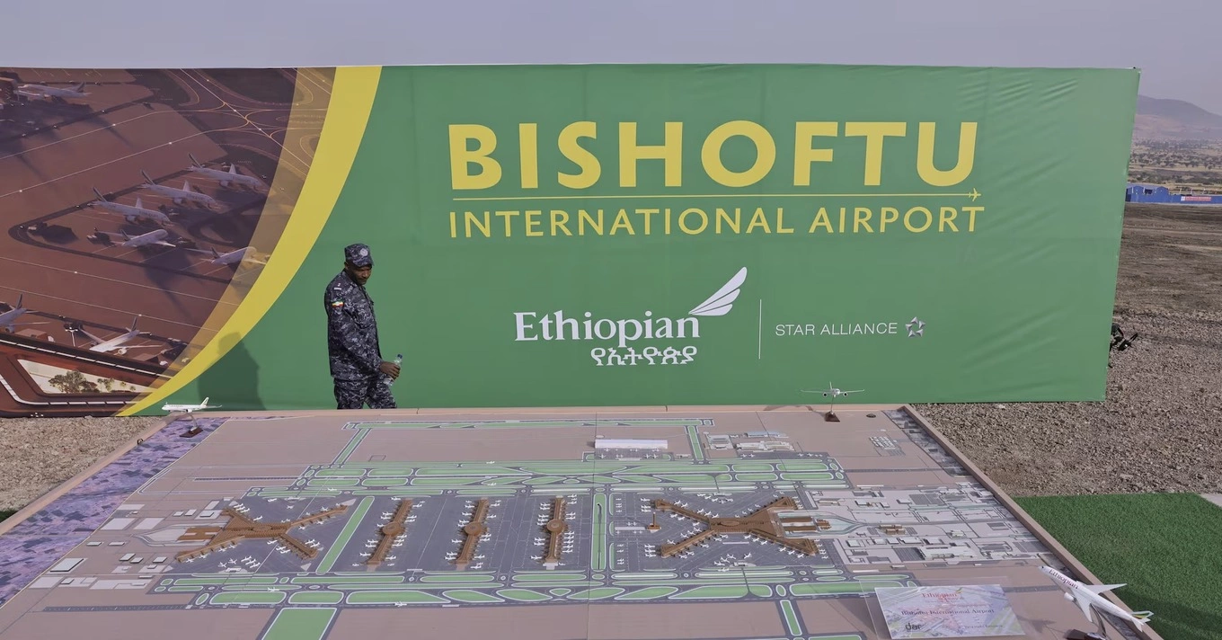 A member of the Ethiopian Federal Police walks past the Bishoftu International Airport design during its construction commencement in Abusera, Ethiopia, January 10, 2026. Photo by Reuters