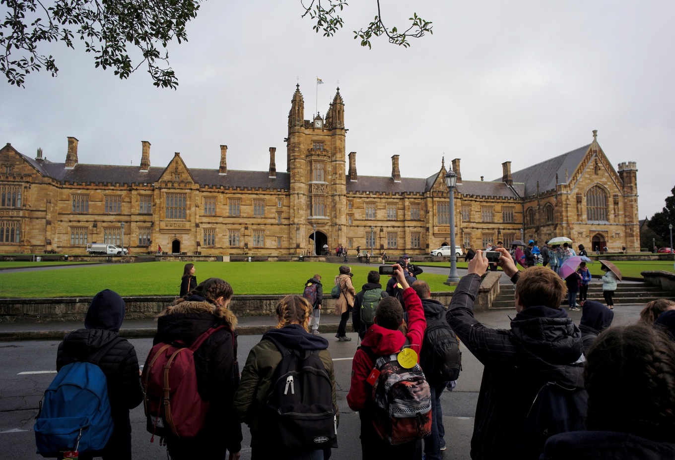 Visitors take pictures of the main building at the University of Sydney in Australia, August 5, 2016. Photo by Reuters