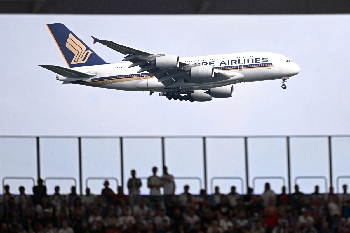 A Singapore Airlines aircraft flies past the Frankfurt Arena during the UEFA Euro 2024 Group E football match between Belgium and Slovakia, in Frankfurt am Main on June 17, 2024. Photo by AFP