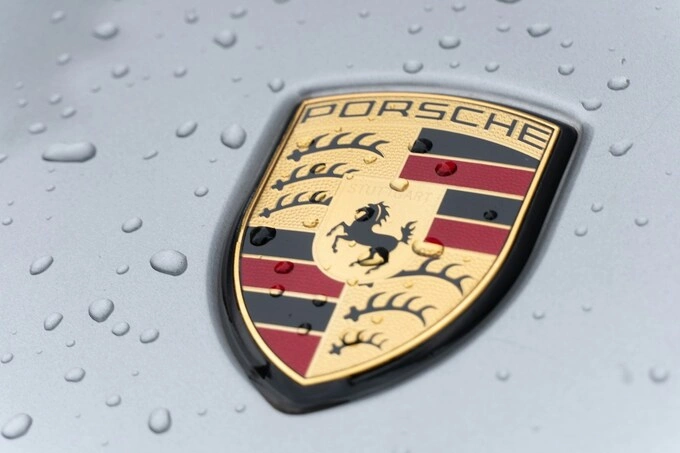 The logo of Porsche. Photo by Unsplash/Caspar Rae