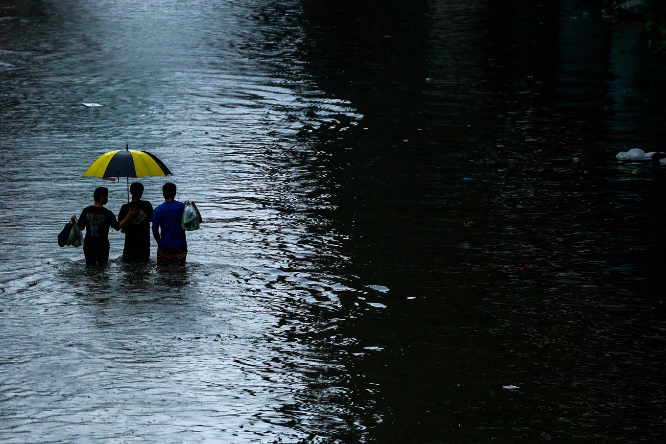 People wade through a flooded street during heavy rain in Bangkok, Thailand, September 26, 2026. Photo by Reuters