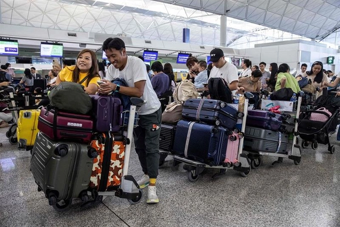 Passengers at Hong Kong International Airport. Photo by AFP
