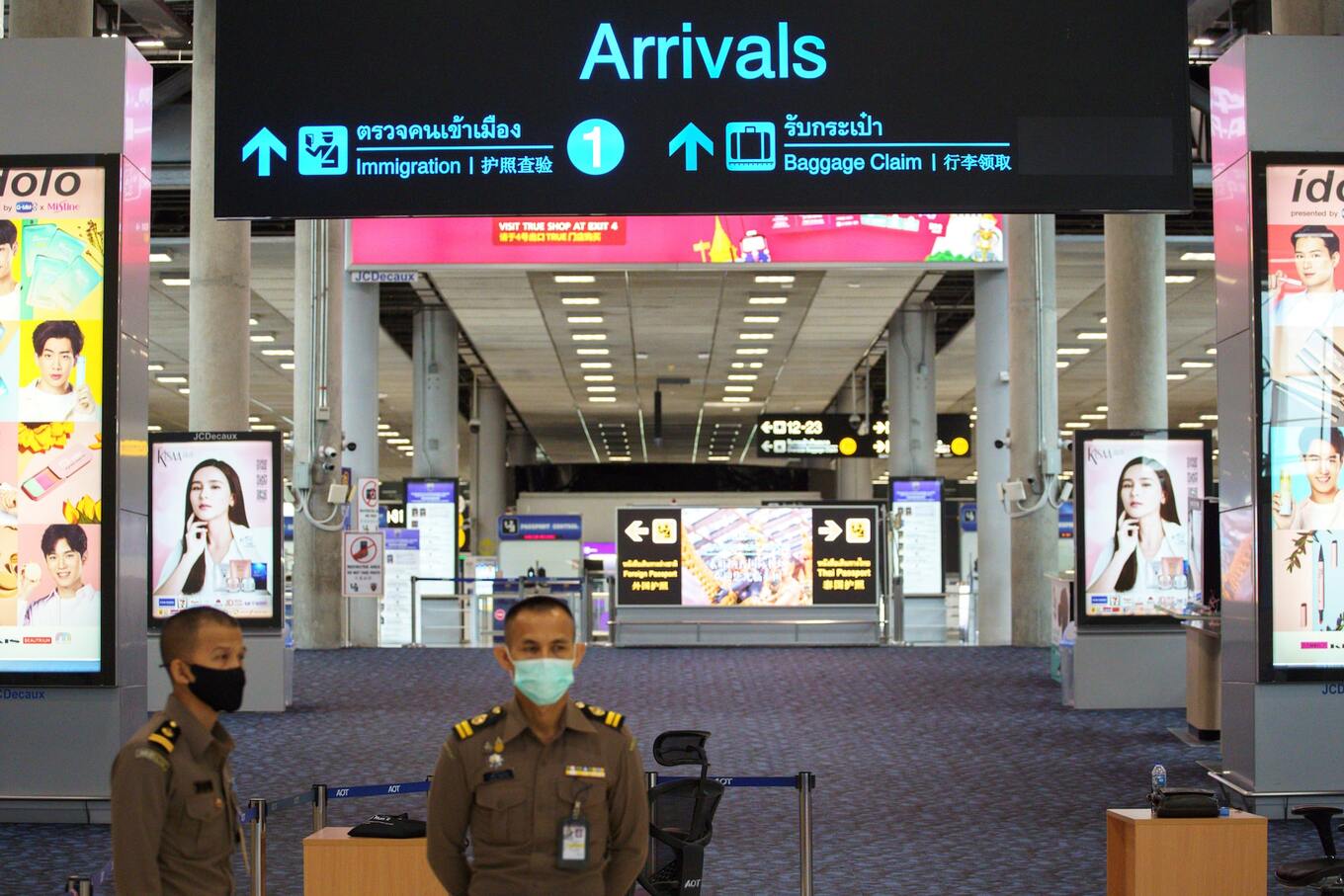 Immigration officers stand in front of an empty arrivals hall at Bangkoks Suvarnabhumi International airport amid the spread of the coronavirus disease (COVID-19), Thailand, June 3, 2020. Photo by Reuters