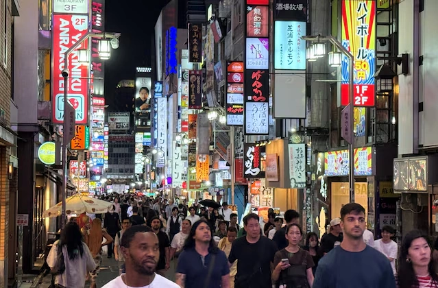 People walk at a shopping area of Shinjuku in Tokyo, Japan in 2025. Photo by Reuters
