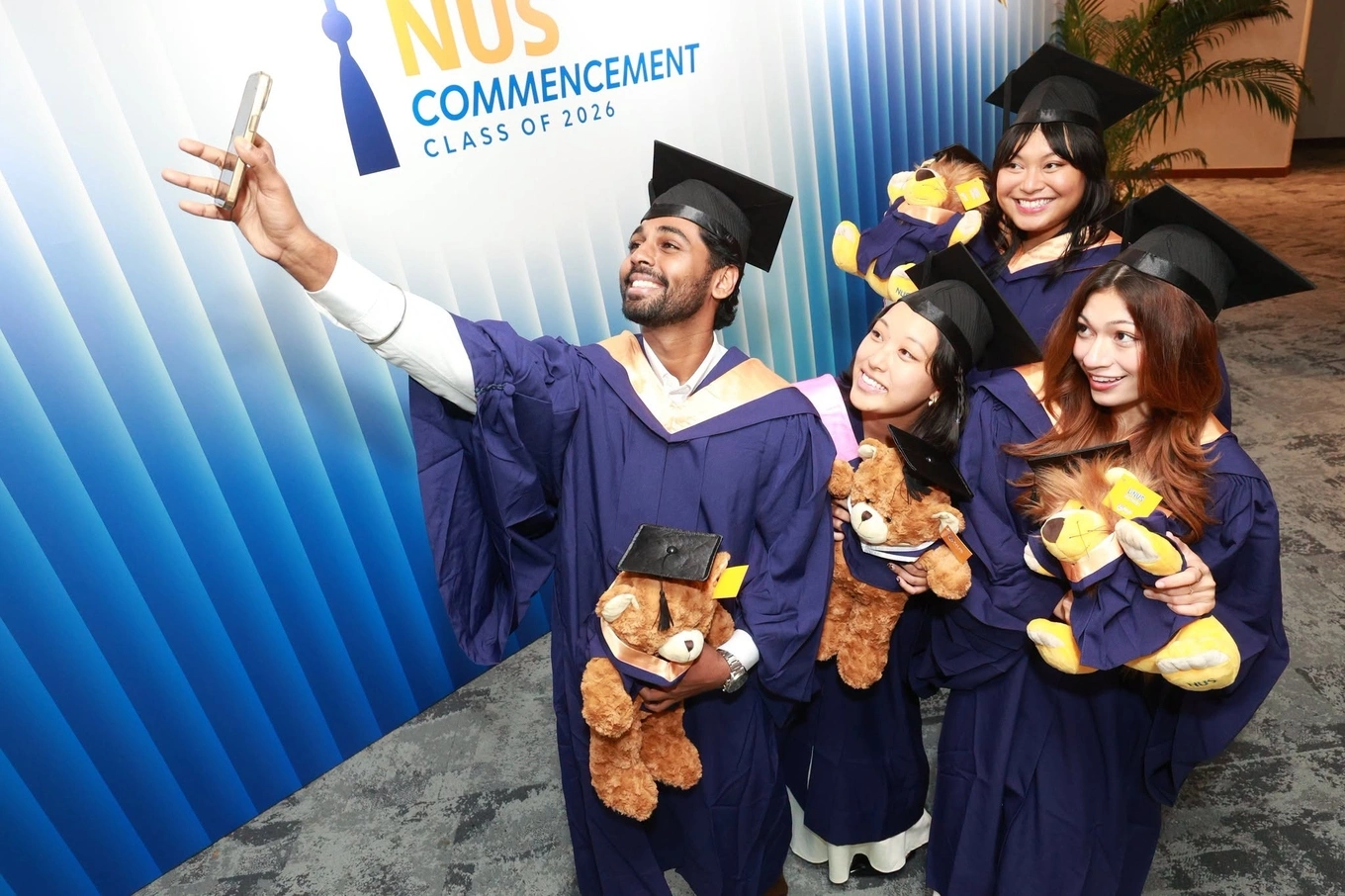 Graduates pose for a selfie during the National University of Singapore (NUS) commencement ceremony for the Class of 2026 on July 23. Photo from the universitys Facebook page