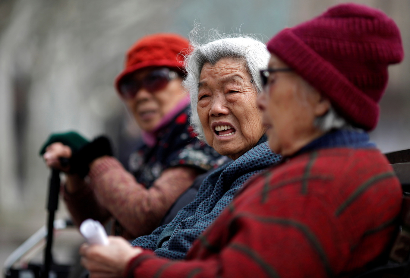 Elderly women sit at a park in downtown Shanghai, China. Photo by Reuters