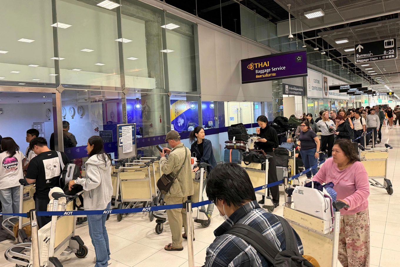 passengers line up in front of the Thai Airways office at Suvarnabhumi Airport to register for luggage they could not claim after flooding affected operations in Bangkok, Thailand, Sept. 27, 2026. Photo by AP