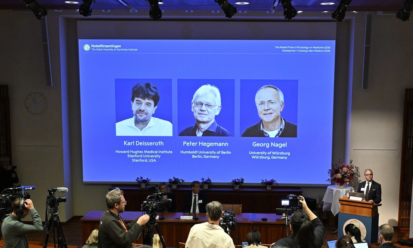 Portraits of Karl Deisseroth, Peter Hegemann and Georg Nagel are shown on the screen as they are awarded the 2026 Nobel Prize in Physiology or Medicine, as announced during a press conference at the Nobel Forum at Karolinska Institutet in Stockholm, Sweden, Oct. 5, 2026. Photo by AP