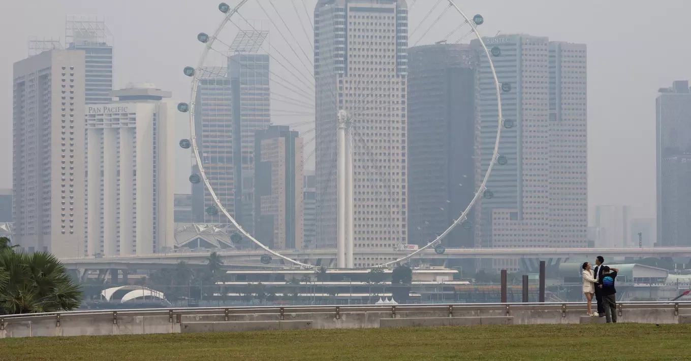 The Singapore Flyer and commercial buildings are shrouded in haze at the Marina Bay area in Singapore, September 15, 2026. Photo by Reuters
