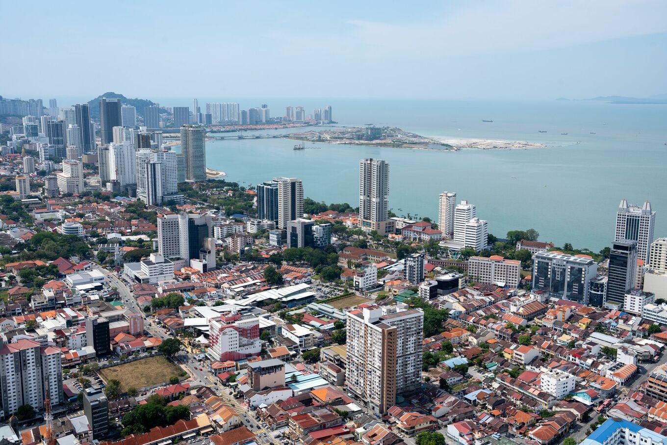 A vibrant aerial view of Penangs urban skyline with a coastal backdrop, showcasing modern architecture, Mar 27, 2024. Photo by pexels