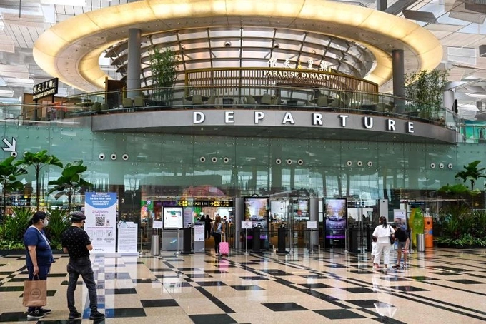 Passengers at Changi Airport in Singapore. Photo by AFP